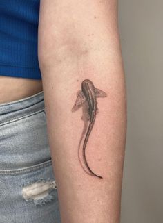 a woman's arm with a lizard tattoo on the left side of her body