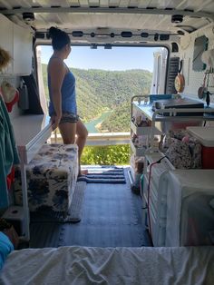 a woman standing in the back of a van