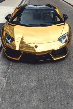 a gold colored sports car parked on the street