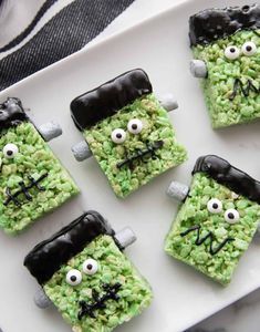 green rice krispy treats with black eyes and googly eyes are on a white plate