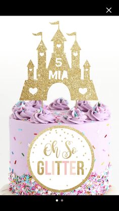 a cake with pink frosting and gold glitter on top, in front of a white background