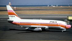 a large passenger jet sitting on top of an airport tarmac next to the ocean