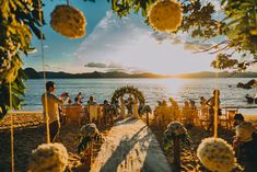 a couple getting married on the beach at sunset