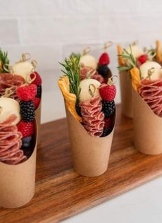 four small cups filled with different types of food