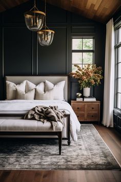 a bedroom with black walls and white bedding