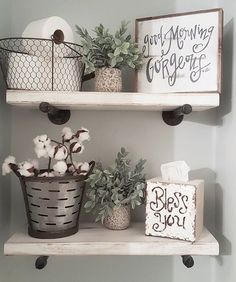 two white shelves with baskets and plants on them