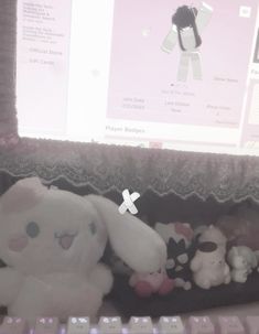 stuffed animals are sitting in front of a computer screen with an x on the keyboard