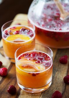 two glasses filled with orange and raspberry punch