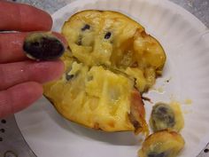 someone is peeling the inside of an eggplant into small pieces on a paper plate