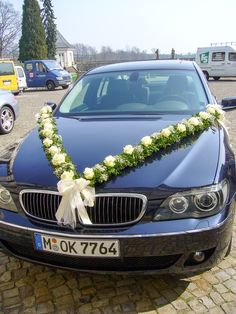 a car decorated with flowers and greenery