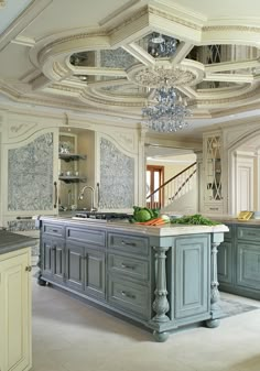 a large kitchen with an island and chandelier hanging from it's ceiling