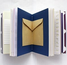 an open book with a paper envelope inside