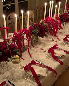 the table is set with candles and place settings