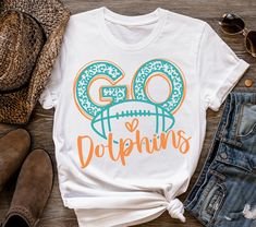 a t - shirt that says go dolphins with an image of a football on it