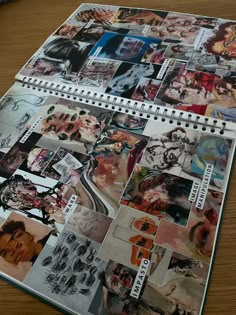 a spiral notebook covered in many different pictures on it's side, sitting on a table