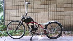 a black and red bike parked next to a building