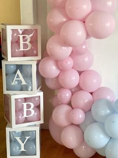 balloons and blocks are arranged in the shape of letters for a baby's first birthday party