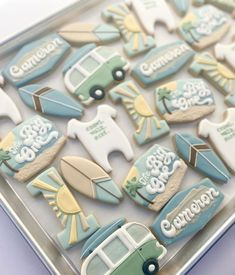 some cookies that are shaped like cars and surfboards in the shape of campers