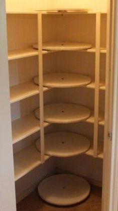 an empty closet with several shelves and lights