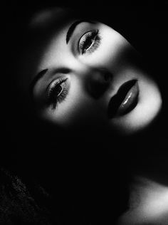 black and white photograph of two women's eyes, one with long lashes on her head