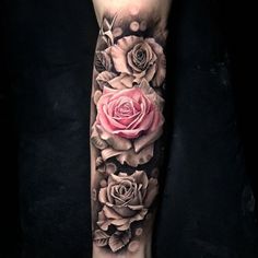 a woman's leg with roses and leaves on it