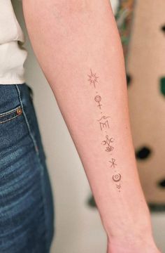 a woman's arm with tattoos on it and the word love written in cursive writing