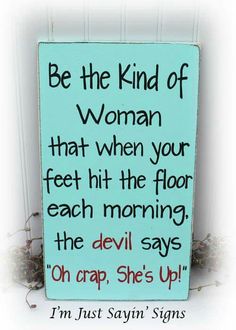 a blue sign with the words be the kind of woman that when your feet hit the floor each morning, the devil says