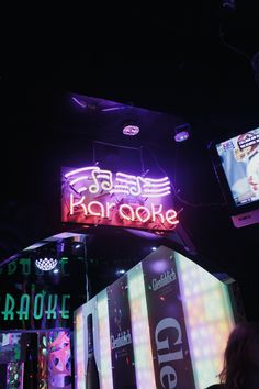 the neon sign is lit up for people to see it on their cell phones at night