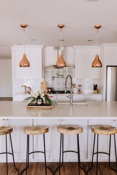 three stools in front of a kitchen island