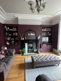 a living room with purple walls and furniture