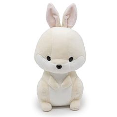 a white stuffed animal with black eyes and ears