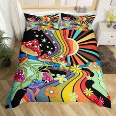 a bed covered in a colorful comforter and pillow case with an abstract design on it