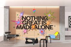 there is a sign that says nothing great is made alone on the wall behind it