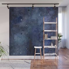 a space themed wall mural in a living room