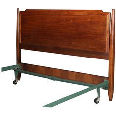 a wooden headboard with wheels attached to it