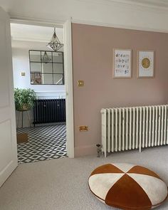 a living room with a radiator and rug on the floor next to it