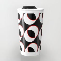 a black and white coffee cup with red circles on it