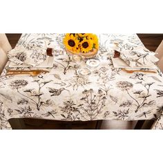 the table cloth has sunflowers on it