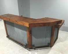 an old wooden box sitting on top of a white floor next to a gray wall