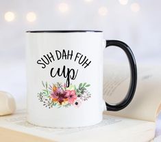 a black and white coffee mug with the words suh dah ful cup on it