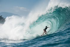 a man riding a wave on top of a surfboard