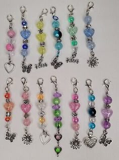 many different colored beads and charms on a white surface