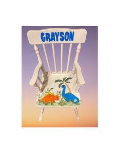 a white plastic rocking chair with dinosaurs painted on the seat and name that says, grayson