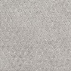 an upholstered fabric textured with small dots and lines in light grey color