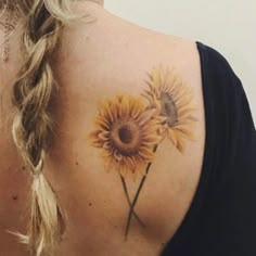 a woman with a sunflower tattoo on her back