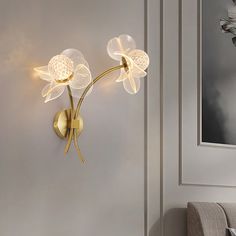 a wall light that has two flowers on it