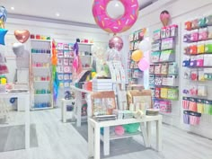 a store filled with lots of different types of items and balloons hanging from the ceiling