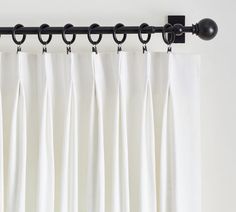 white curtains with black rings hanging from them