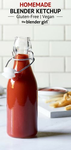 a glass bottle filled with ketchup sitting on top of a counter