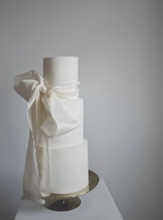 a white wedding cake with a bow on top